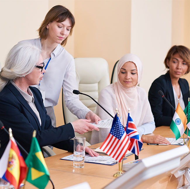 young-secretary-giving-documents-to-one-of-intercu